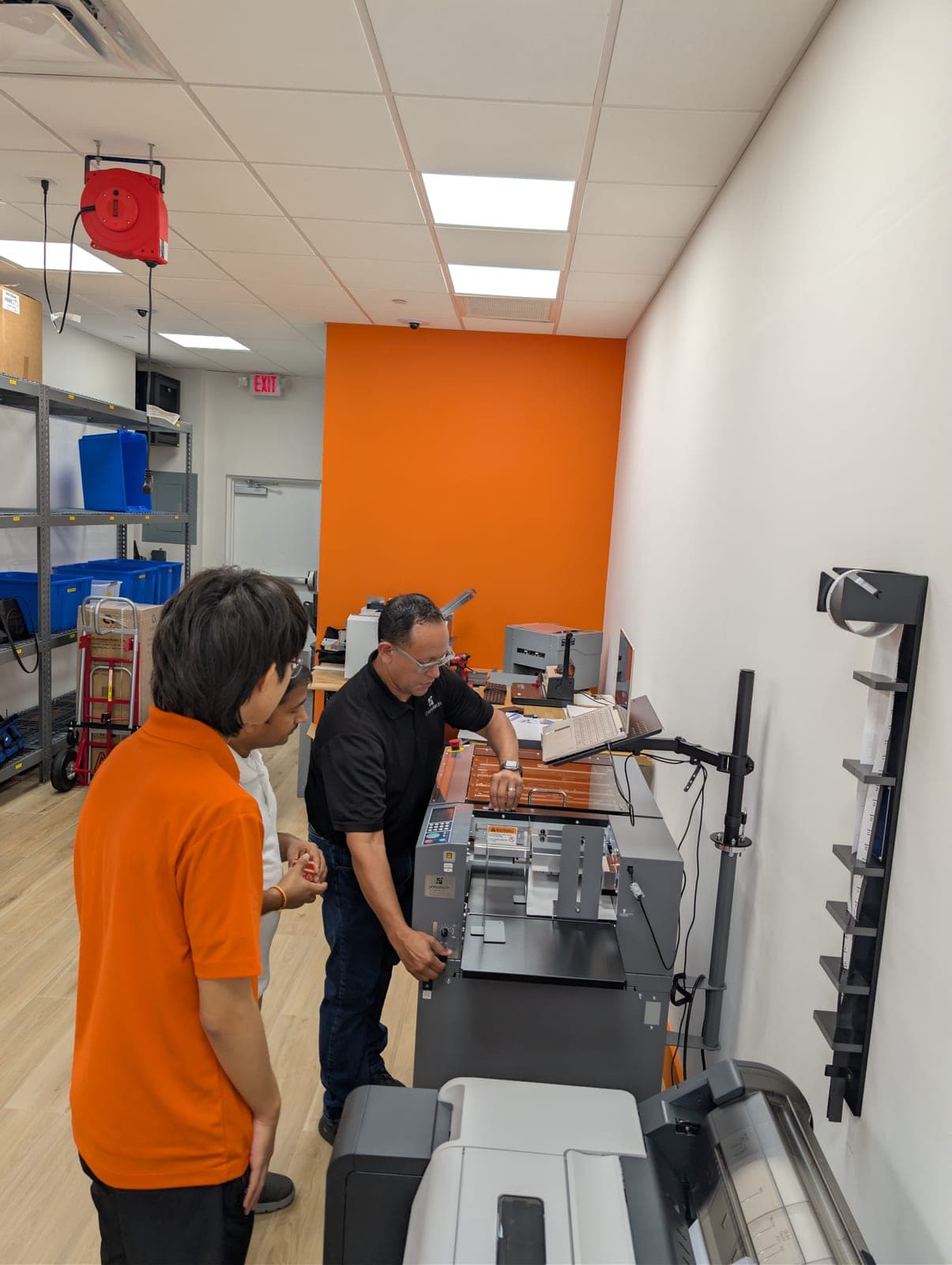 PressTech technician installing a finishing machine at a customer's print shop