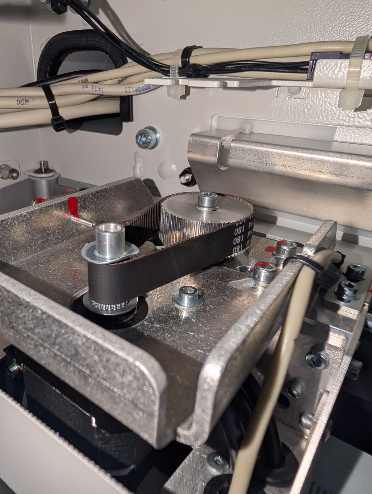Drive belt and pulley inside a print finishing machine during a preventive maintenance visit